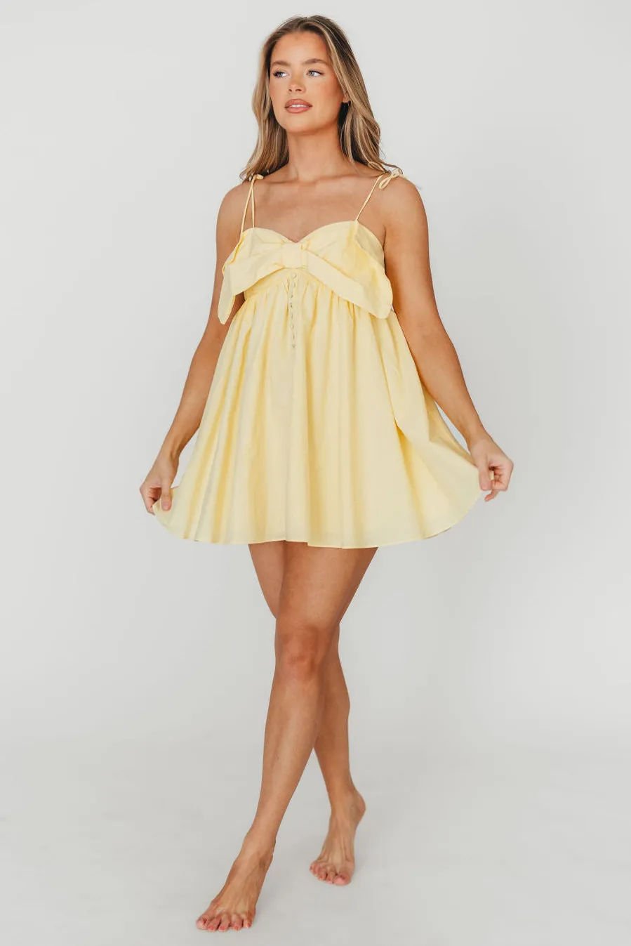 Irelyn Babydoll Mini Dress with Bow Accent in Yellow